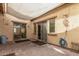 The outdoor patio features custom sunshade, hardscape pavers and stucco walls for privacy at 10239 W Via Del Sol -- # 400, Peoria, AZ 85383