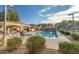 Exterior community pool and seating area with lush landscape at 10239 W Via Del Sol -- # 400, Peoria, AZ 85383
