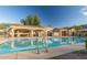 Community pool with lounge chairs, picnic tables and covered seating areas at 10239 W Via Del Sol -- # 400, Peoria, AZ 85383