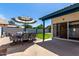 Backyard patio with shade umbrella and seating for entertaining at 1279 N Blackstone Dr, Chandler, AZ 85224