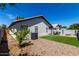 Wide shot of home's backyard with artificial turf, seating, and citrus tree at 1279 N Blackstone Dr, Chandler, AZ 85224