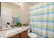 Bathroom with granite counters, stylish shower curtain, and modern fixtures at 1279 N Blackstone Dr, Chandler, AZ 85224