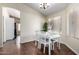 Bright dining room with a white table set and hardwood flooring at 1279 N Blackstone Dr, Chandler, AZ 85224