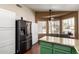 Kitchen with stainless steel refrigerator, granite countertops, island with seating, and breakfast nook with bay windows at 1279 N Blackstone Dr, Chandler, AZ 85224