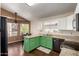 Bright eat-in kitchen with green cabinets, granite countertops, and views to backyard at 1279 N Blackstone Dr, Chandler, AZ 85224