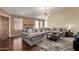 Cozy living room with hardwood floors, a large sofa, and modern lighting fixtures at 1279 N Blackstone Dr, Chandler, AZ 85224