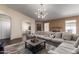 Spacious living room with a large sofa, fireplace, and view to dining area at 1279 N Blackstone Dr, Chandler, AZ 85224