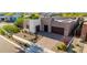 Aerial view of a modern home with desert landscaping, solar panels, and a paver driveway at 1330 E Monte Way, Phoenix, AZ 85042