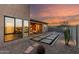 An ample backyard features a covered patio, fire pit, custom paver design, and low maintenance landscaping at 1330 E Monte Way, Phoenix, AZ 85042