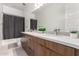 Bright bathroom with a double sink vanity, modern fixtures, ample storage space, and a shower-tub combo at 1330 E Monte Way, Phoenix, AZ 85042