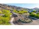 Welcoming community entrance with desert landscaping, plants, and mountain views at 1330 E Monte Way, Phoenix, AZ 85042