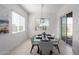 Elegant dining area with modern light fixture and sliding glass doors that provide great natural light at 1330 E Monte Way, Phoenix, AZ 85042