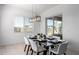 Bright dining area with modern light fixture and sliding glass doors that provide great natural light at 1330 E Monte Way, Phoenix, AZ 85042