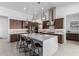 Modern kitchen with a large island, pendant lighting, stainless steel appliances, and ample cabinet space at 1330 E Monte Way, Phoenix, AZ 85042