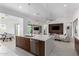 Bright open kitchen with stainless appliances and center island that overlooks the dining and living areas at 1330 E Monte Way, Phoenix, AZ 85042