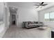 Bright living room featuring neutral-toned decor, tile flooring, and a modern ceiling fan for added comfort at 1330 E Monte Way, Phoenix, AZ 85042
