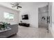 Cozy living room with tile floor, TV, fan, and large windows with bright sunlight at 1330 E Monte Way, Phoenix, AZ 85042