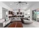 Bright, open-concept living space with modern furnishings flowing into a kitchen with a large island at 1330 E Monte Way, Phoenix, AZ 85042