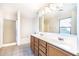 Bright bathroom with dual sinks, vanity, and a separate shower and tub at 15028 W Columbine Dr, Surprise, AZ 85379