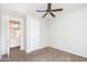 A bright bedroom featuring a ceiling fan with an open doorway at 15028 W Columbine Dr, Surprise, AZ 85379