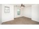 Bright bedroom featuring two sunlit windows and a modern ceiling fan at 15028 W Columbine Dr, Surprise, AZ 85379
