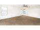 Spacious bedroom bathed in natural light with three large windows at 15028 W Columbine Dr, Surprise, AZ 85379