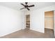 Bright bedroom with closet and open doorway to staircase at 15028 W Columbine Dr, Surprise, AZ 85379