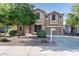 Charming two-story home showcasing a well-maintained front yard and appealing architectural details at 15028 W Columbine Dr, Surprise, AZ 85379