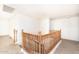 This bright hallway features decorative wooden railings and carpeted flooring at 15028 W Columbine Dr, Surprise, AZ 85379