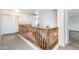 Hallway with wooden railing and access to rooms with lots of light at 15028 W Columbine Dr, Surprise, AZ 85379