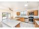 Bright kitchen with a view to the outdoors, stainless steel appliances, and an island, perfect for cooking at 15028 W Columbine Dr, Surprise, AZ 85379