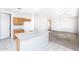 Open kitchen featuring ample countertops and an island, adjacent to a cozy living area, perfect for hosting at 15028 W Columbine Dr, Surprise, AZ 85379