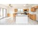 Bright, open kitchen with an island and stainless appliances, offering a seamless cooking and entertaining experience at 15028 W Columbine Dr, Surprise, AZ 85379