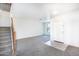 Open-concept living area with staircase, carpet, and bright natural light at 15028 W Columbine Dr, Surprise, AZ 85379