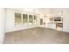 Bright living room features three large windows overlooking the backyard pool at 15028 W Columbine Dr, Surprise, AZ 85379