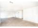 Spacious carpeted living room with neutral walls and ample natural light, perfect for comfortable living at 15028 W Columbine Dr, Surprise, AZ 85379