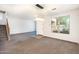Bright living room with neutral walls, large window, and staircase to the left at 15028 W Columbine Dr, Surprise, AZ 85379