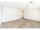 Empty living room with neutral carpet and bright white walls and ceiling at 15028 W Columbine Dr, Surprise, AZ 85379