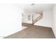 Spacious living room with open layout, carpet, and easy access to the staircase at 15028 W Columbine Dr, Surprise, AZ 85379