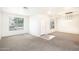 Carpeted living room featuring a tiled entryway and a bright front entrance at 15028 W Columbine Dr, Surprise, AZ 85379