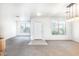 Open living room near the front door features a carpeted floor and ample natural light at 15028 W Columbine Dr, Surprise, AZ 85379
