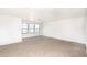 Spacious living room featuring wall-to-wall carpeting and three sunlit windows at 15028 W Columbine Dr, Surprise, AZ 85379