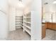 Large pantry features open shelving and tile floors, conveniently located near the kitchen at 15028 W Columbine Dr, Surprise, AZ 85379