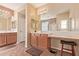 Spacious bathroom with double sinks, ample counter space, a makeup vanity, and natural lighting at 15288 W Redfield Rd, Surprise, AZ 85379