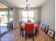 Bright dining room with a view of the backyard, featuring a table set for six and access to the outdoor area at 15288 W Redfield Rd, Surprise, AZ 85379