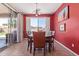 Dining area features a table with four chairs, tile flooring, and large window at 15288 W Redfield Rd, Surprise, AZ 85379
