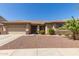 Charming single-story home featuring a two-car garage and desert landscaping at 15288 W Redfield Rd, Surprise, AZ 85379