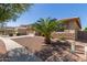 Charming home with desert landscaping and a young palm tree in the front yard at 15288 W Redfield Rd, Surprise, AZ 85379