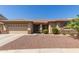 Charming single-story home featuring a two-car garage and desert landscaping at 15288 W Redfield Rd, Surprise, AZ 85379
