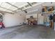 Spacious garage with white walls, cement floors, storage shelving and workbench at 15288 W Redfield Rd, Surprise, AZ 85379